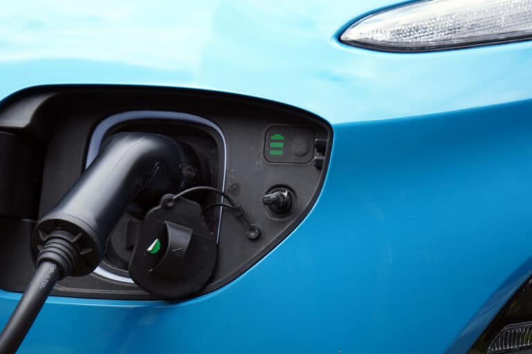A blue electric car is being charged.