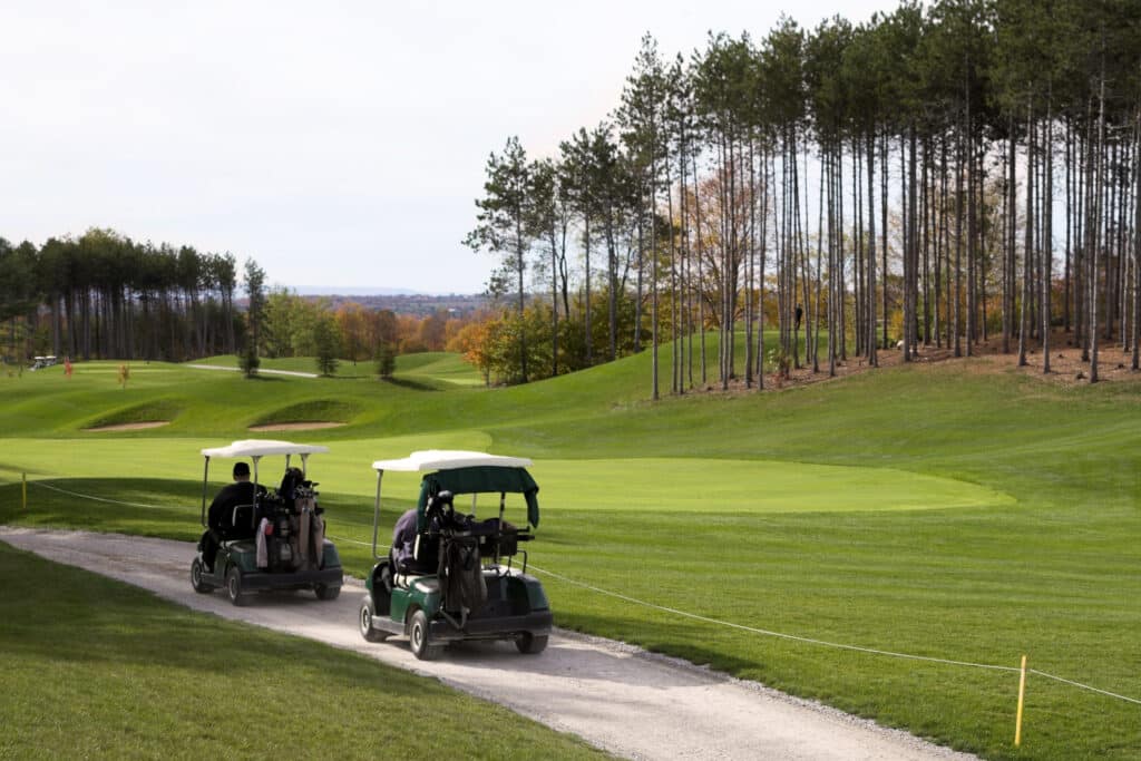 Two golf carts in use on a golf course.